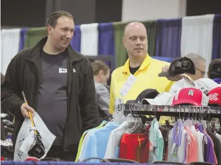  ??  ?? GEARING UP: Attendees at the 2017 National Golf Expo in Boston check out the gear for sale. Expect to see all sorts of clothing and equipment at this year’s expo.