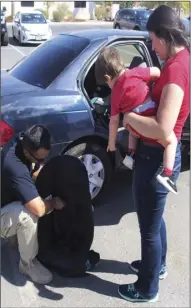  ??  ?? California Highway Patrol officer shows a mom proper use of the new car seat she received Saturday at the car seat clinic at Pioneers Memorial Hospital. PHOTO TOM BODUS