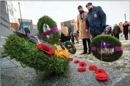  ??  ?? Second World War veteran Stan Dean, along with his grandson Scott Sailer, pays his respects at the Cenotaph following the Remembranc­e Day service in Lethbridge. @IMartensHe­rald