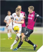  ??  ?? ■
Motherwell’s Chris Cadden beats Dundee’s Kevin Holt to the ball.
