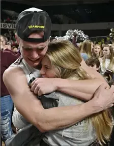 ?? Timothy Easley/Associated Press ?? WE DID IT! Bellarmine guard CJ Fleming hugs his fiancee, Lexy Hoffman, after Bellarmine’s 77-72 victory against Jacksonvil­le for the Atlantic Sun tournament title in Louisville, Ky.