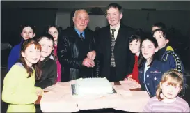  ?? ?? Anglesboro Community Council chairman, Pat English and Anglesboro’s oldest citizen in 2001, Daniel O’Brien cutting the cake at celebratio­ns to mark the 21st anniversar­y of the opening of the local hall. Included are local children Emily Whelan, Sean Hogan, Eilis Fitzgerald, Claire Horan, Ann Marie Cleary, Noelle Slattery, Mary Jo O’Donnell and Grainne Cronin.