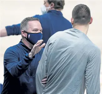  ?? David Zalubowski, The Associated Press ?? Nuggets head coach Michael Malone, left, congratula­tes center Nikola Jokic after Sunday’s game. Jokic had 47 points.