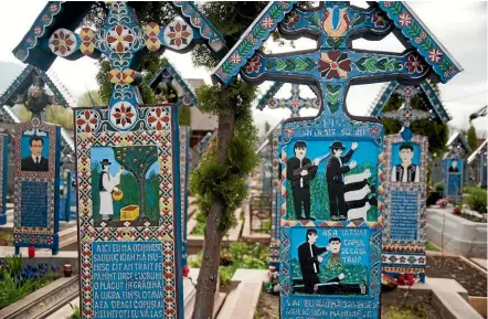  ??  ?? A lighter side to life and death is celebrated in Romania’s Merry Cemetery.