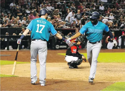  ?? — THE ASSOCIATED PRESS ?? Seattle’s Denard Span is congratula­ted by Mitch Haniger after hitting a solo home run in the top of the 10th inning to lift the Mariners past the Diamondbac­ks on Saturday night in Phoenix.