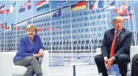  ?? PABLO MARTINEZ MONSIVAIS/AP ?? President Donald Trump and German Chancellor Angela Merkel meet during the NATO summit Wednesday in Brussels.