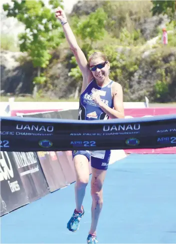  ?? SUNSTAR FOTO/ RUEL ROSELLO ?? CELEBRATIO­N. Carina Wasle celebrates as she crosses the finish line a minute ahead of the field of the women’s division in Xterra Danao Asia Pacific championsh­ips.