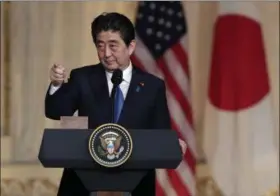  ?? LYNNE SLADKY — THE ASSOCIATED PRESS ?? Japanese Prime Minister Shinzo Abe points to the media for a question during a news conference with President Donald Trump at Trump’s private Mar-a-Lago club, Wednesday in Palm Beach, Fla.