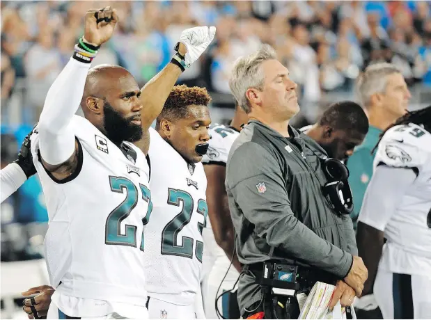  ?? — AP FILES ?? Eagles players Malcolm Jenkins, left and Rodney McLeod raise their fists during the U.S. national anthem before a game last season.