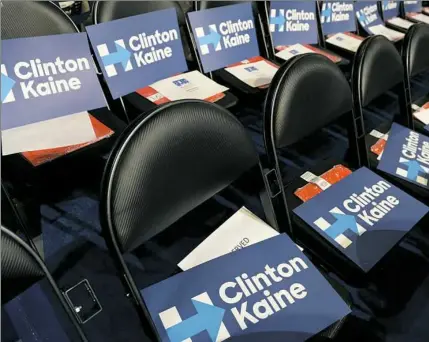  ??  ?? The seats, complete with signs, are ready for delegates on the final day of the Democratic National Convention.