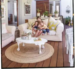  ??  ?? Mom Carla, Ankia and Arno (left) relax on the deck that Charl built and installed. Wooden screens on the window behind them enhance the farm-style aesthetic.