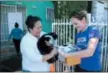  ?? ASPCA VIA AP ?? This December 2015 photo provided by the ASPCA shows ASPCA L.A. Community Engagement Manager Denise Bohn, right, delivering supplies to a client, a cat named Oreo and her owner Josefina Tejada in Los Angeles.