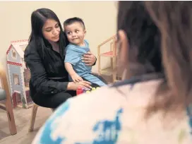  ?? CARL JUSTE cjuste@miamiheral­d.com ?? Darwin Lopez, 2, looks toward his mother, Teresa Lopez, 19, during parent-child interactio­n therapy. The leaders of Lotus Village plan to raise $20 million to add a five-story Children’s Village focusing on education and mental health.