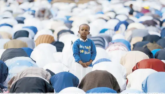  ?? REUTERS ?? A boy stands as Muslim faithful attend Eid’l Fitr prayers, marking the end of the holy fasting month of Ramadan, at the Sir Ali Muslim Club Ground in the Ngara district of Nairobi, Kenya yesterday.