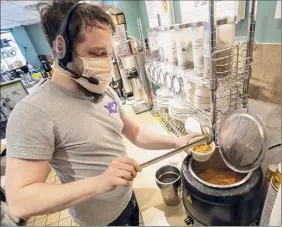  ?? James Franco / Special to the Times Union ?? Marcus Solga, a chef at the Kaffee House Restaurant on West Avenue, ladles out a bowl of Lentil Chowder on Saturday.