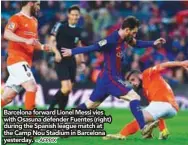  ?? – AFPPIX ?? Barcelona forward Lionel Messi vies with Osasuna defender Fuentes (right) during the Spanish league match at the Camp Nou Stadium in Barcelona yesterday.