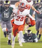  ?? JIM THOMPSON/JOURNAL ?? UNM’s Tyrone Owens (25), shown running for a TD last year, made Lindy’s College Football Magazine’s all-MWC first team.