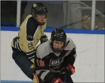  ?? KEN SWART — FOR MEDIANEWS GROUP ?? Birmingham Unified’s Kelton Carr (10) controls the puck in front of Stoney Creek’s Liam Pritchard during OAA Red match-up played on Friday at Suburban Ice in Rochester. The Kings defeated the Cougars 10-0.