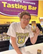  ?? BRIAN E. CLARK ?? Barry Levenson, curator and chief mustard officer at the National Mustard Museum in Middleton, shows off a jar of Gorman Thomas Stormin’ Sauce at the museum’s tasting bar.
