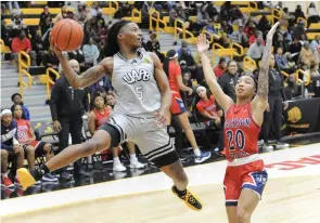  ?? Commercial/William Harvey) (Special to the ?? UAPB guard Jelissa Reese (5) attempts a midair pass while guarded by Jackson State guard Areyanna Hunter (20) during Monday night’s women’s basketball game at H.O. Clemmons Arena in Pine Bluff.