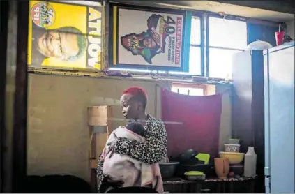  ??  ?? Family life: Wendy Ndebele (above) moved to the hostel where her sister lives after she fell pregnant. Her baby Melokuhle is now eight months old. They’ve turned their room into a home, with little touches of warmth (right). Photos: Lizzy Muholi