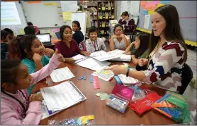  ?? NWA Democrat-Gazette/ANDY SHUPE ?? Vanessa Stewart, a fourth-grade teacher at Monitor Elementary School in Springdale, works with students Tuesday on a lesson about fractions during class at the school. Stewart is one of four finalists for Teacher of the Year in the state.