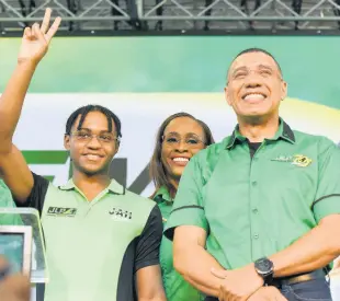  ?? IAN ALLEN/PHOTOGRAPH­ER ?? Prime Minister Andrew Holness and wife Juliet Holness introduce their son, Matthew, to suppporter­s during the Jamaica Labour Party’s 79th annual conference at the National Arena on Sunday.