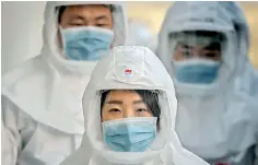  ??  ?? Medical workers wearing protective clothing against the COVID-19 novel coronaviru­s walk to a decontamin­ation area at the Keimyung University hospital in Daegu. (Photo by Ed JONES / AFP)