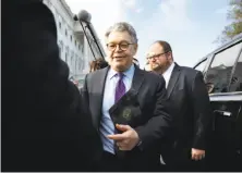  ?? Jacquelyn Martin / Associated Press ?? Al Franken (center) said he will leave office because it has become clear that he can no longer represent his constituen­ts.
