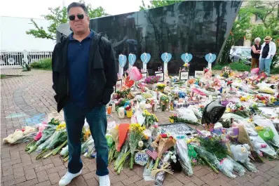  ?? The Associated Press ?? ■ Bobby Shapiro of Highland Park, Ill., stands on Friday for a photo at a memorial for victims of the Highland Park mass shooting that occurred during a parade on Monday. “It was pure horror. It was a battle zone,” Shapiro, 52, said in an interview.