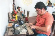  ?? LUIS ACOSTA / AGENCE FRANCE-PRESSE ?? A goldsmith works on silver filigree jewelry in the town of Mompox, Colombia, where an Arab tradition has been handed down by generation­s.