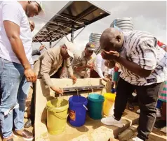  ?? ?? Director of the Presidenti­al Borehole Scheme Dr Paul Tungwarara (second from left) and Mbare Member of Parliament Cde Martin Matinyanya (third from left) drink some water during the handover of recently drilled boreholes in Mbare last Friday