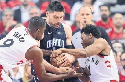  ?? FRANK GUNN THE CANADIAN PRESS ?? Raptors' big man Serge Ibaka has helped frustrate Orlando’s Nikola Vucevic in the first two games of their playoff series.