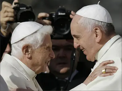  ?? Gregorio Borgia/Associated Press ?? Pope Francis, right, hugs Pope Emeritus Benedict XVI before the start of a 2014 meeting with elderly faithful in St. Peter’s Square at the Vatican. Pope Francis said Wednesday his predecesso­r is “very sick,” and he asked the faithful to pray for the retired pontiff so God will comfort him “to the very end.”