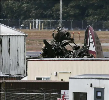  ?? AP PHOTO/JESSICA HILL ?? Wreckage is seen where World War II-era bomber plane crashed at Bradley Internatio­nal Airport in Windsor Locks, Conn., Wednesday, Oct. 2, 2019. A fire with black smoke rose from near the airport as emergency crews responded. The airport said in a message on Twitter that it has closed.