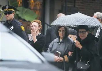  ?? Alexandra Wimley/Post-Gazette ?? A woman blows a kiss to the hearse as the funeral procession for Richard Gottfried pulls away from the funeral Thursday at Ralph Schugar Chapel in Shadyside.