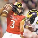  ?? JULIO CORTEZ/AP ?? Maryland quarterbac­k Taulia Tagovailoa tries to avoid a sack by Michigan defensive end TJ Guy during a 59-18 loss to the No. 6 Wolverines.