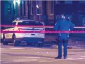  ?? TYLER LARIVIERE/ SUN- TIMES ?? An officer guards the scene of a shooting early Saturday in the 6600 block of South Drexel.