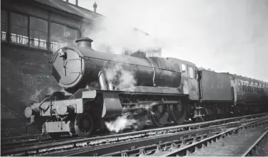  ?? Roger Venning/Kiddermins­ter Railway Museum ?? Released to traffic in mid-February 1946, at 6.15pm on 10 June that year we find yet to be named Hawksworth ‘County’ class 4-6-0 No 1014 standing by the signal box in Taunton station’s platform 5 with a down Bristol to Taunton stopping train. A Bristol (Bath Road) engine from new, a name would follow in March 1948, County of Glamorgan, the lengthy splasher ideal for a modern looking straight plate.
