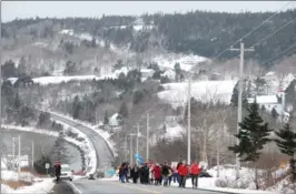  ?? GARY WILSON, THE CANADIAN PRESS ?? People trek along a rural road in Sandy Cove, N.S., on Saturday, in solidarity with hundreds of other marches for women’s rights around the globe. A plucky group of 15 women who charmed the internet with their small-scale women’s march through a rural...