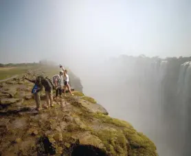  ??  ?? Right: Visitors taking selfies at the Falls. You can’t help but get close to the edge!
Below left: The sun streaming onto the veranda at The Elephant Camp. We loved spotting ellies and other wildlife through the telescope.
Below right: Sylvester the...