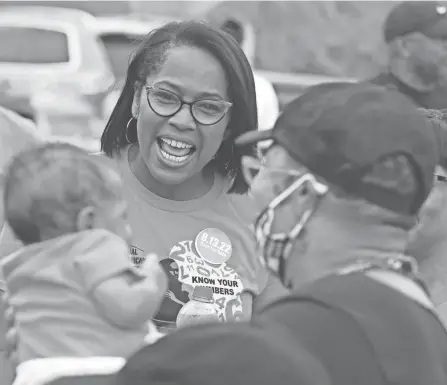  ?? DORAL CHENOWETH/COLUMBUS DISPATCH ?? Columbus Police Chief Elaine Bryant greets 3-month-old Aero Small, who is being held by his grandmothe­r, Tracey Daniels, along the route for the African-american Male Wellness Walk on Aug. 14.