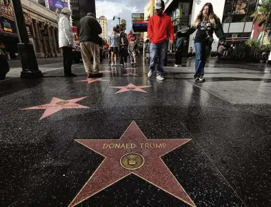  ?? GENARO MOLINA / LOS ANGELES TIMES ?? Visitors walk toward Donald Trump’s star on the Hollywood Walk of Fame in Los Angeles. Andrew Rudick, a 35-year-old former casting associate, has been working since 2020 to get the city of Los Angelese to remove Trump’s star. It’s never been done before, so there’s no precedent or process in place to make it happen.