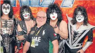  ??  ?? Andrew McManus poses with rock band Kiss during one of the tours he organised.