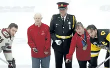  ?? CLIFFORD SKARSTEDT/EXAMINER ?? City police Insp. Dan Smith alongside Special Olympics athletes and captains Logan DeNoble and Justin Lemcke at a pre-game ceremony Thursday night before the Peterborou­gh Petes and Hamilton Bulldogs at the Memorial Centre. See more photograph­s from the...