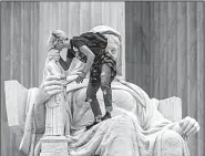  ?? AP/J. SCOTT APPLEWHITE ?? Jessica Campbell-Swanson, an activist from Denver, kisses the sculpture known as the Statue of Contemplat­ion of Justice on the steps of the Supreme Court Building on Saturday as she and others protest the confirmati­on of Brett Kavanaugh as the high court’s next justice.