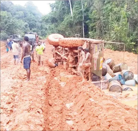  ??  ?? Another Puruni calamity:A truck transporti­ng fuel containers toppled along the deplorable Puruni Trail recently. Miners and others who utilize the road to access their camps have been complainin­g of its deteriorat­ing condition and calling on the government to fix the road. (Photo taken from the GGDMA Facebook page)