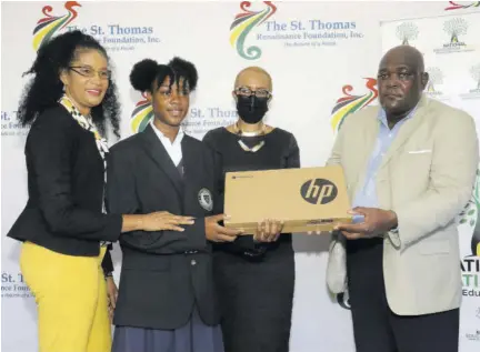  ?? (Photos: Llewellyn Wynter) ?? St Thomas High School student Petra-kay Mcqueen (second left) is presented with a Chromebook by St Thomas Renaissanc­e Foundation Master Maths teacher Beverley Hyatt (left) and Professor Malton Edwards (right), president of the foundation, to the delight of Education Minister Fayval Williams. Occasion was the presentati­on of 1,100 of the devices to the foundation last Friday. The Chromebook­s were a gift from American multinatio­nal technology company Google.