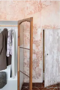  ??  ?? Bedroom A wardrobe has been created using shutters that originally protected the windows. The portrait sitting on the pale pink radiator is part of Sara’s family’s collection of paintings from the late 1700s
Below These ceiling decoration­s are thought to be from the same era