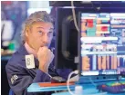  ?? RICHARD DREW/ASSOCIATED PRESS ?? Trader John Romolo works at the New York Stock Exchange on Wednesday. Stocks fell sharply after the bond market raised a warning flag on the economy.